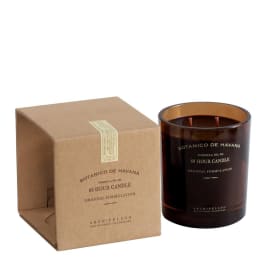 Brown boxed candle beside an amber glass jar candle