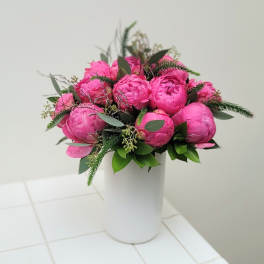 Pink peony bouquet in a white vase
