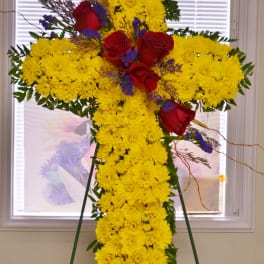 Yellow chrysanthemum cross with red roses on an easel