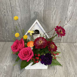 Bright bouquet with pink roses, burgundy blooms, and yellow pom flowers