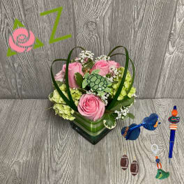 Pink roses and green hydrangeas in a heart-shaped container