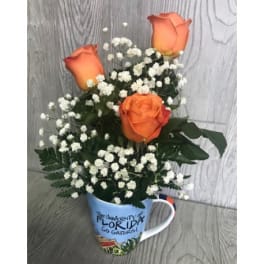 Orange roses in a Florida mug with white baby's breath