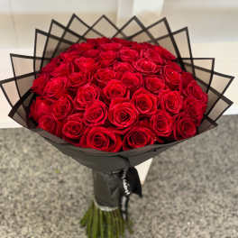 Bouquet of red roses wrapped in black paper
