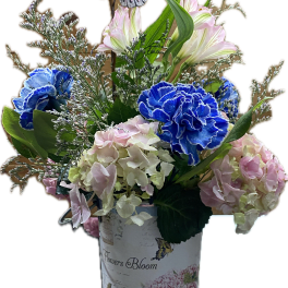 Blue and pink flowers in a decorative vase with a butterfly pick