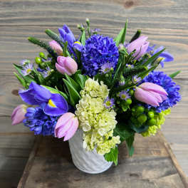 Bouquet of purple and pink flowers in a white vase