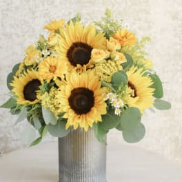 Yellow sunflower and rose arrangement in a tall galvanized metal vase
