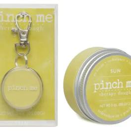 Yellow tin of therapy dough with a keychain in packaging
