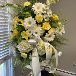 Tall white and yellow floral standing spray with ribbon