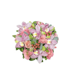 Pink roses and lavender orchids in a compact bouquet