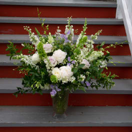 Mixed white and lavender bouquet in a clear glass vase