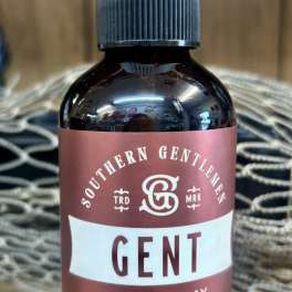 Brown room spray bottle with a clear cap and maroon label