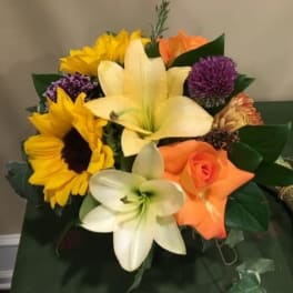 Bouquet with sunflowers, lilies, and orange roses