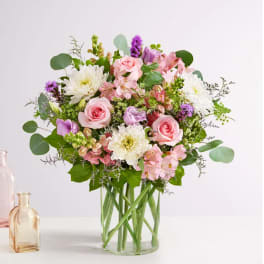 Pink and white mixed bouquet in a clear glass vase