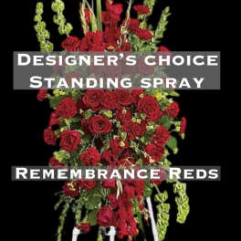 Red standing spray with roses and carnations on a white easel