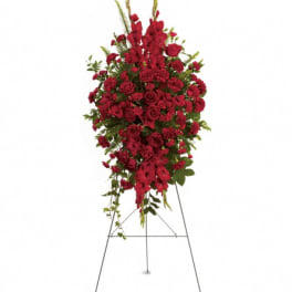 Red floral standing spray on a metal easel