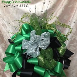 Decorative bow arrangement in green, black, and silver ribbons