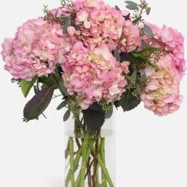 Pink hydrangea bouquet in a clear glass vase