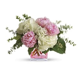 Pink and white peonies in a pink glass vase