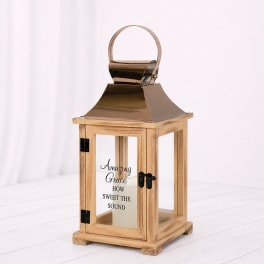 Wooden lantern with a metal top and glass panels