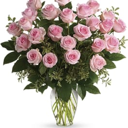 Pink roses arranged in a clear glass vase