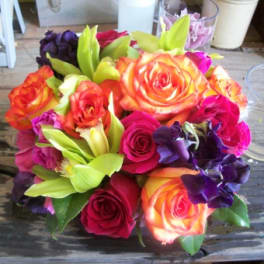 Bouquet of multicolored roses with green orchids