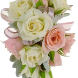 Bouquet of white and blush roses with pink ribbon accents