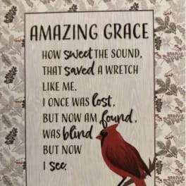 Decorative sign with a cardinal and religious text