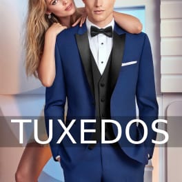 A man in a blue tuxedo with a woman leaning on his shoulder