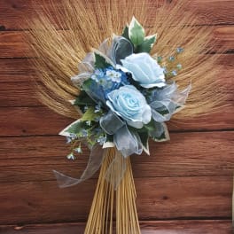 Blue rose bouquet with ribbon and dried grass fan
