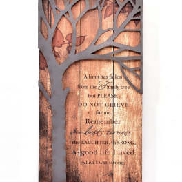 Wooden memorial sign with a tree silhouette and sympathy message