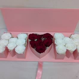 Pink gift box with white and red roses arranged in compartments