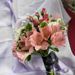 Pink and white flower bouquet with a black ribbon wrap