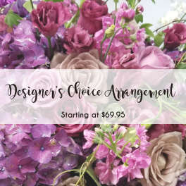 Purple and pink floral arrangement with roses and hydrangeas