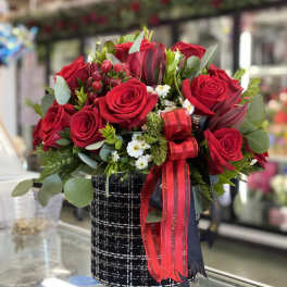 Red rose bouquet in a black patterned box with ribbon