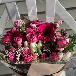 Pink and white mixed bouquet wrapped in paper and clear plastic