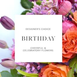 Birthday card over a colorful bouquet of roses and purple flowers