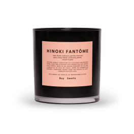 Black scented candle in a glass jar with a pink label