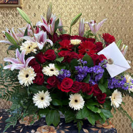 Large bouquet of red roses, lilies, gerbera daisies, and purple flowers