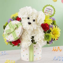 White teddy bear floral arrangement in a polka-dot gift box with birthday signs