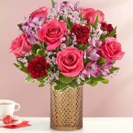Pink and red rose bouquet in a textured gold vase