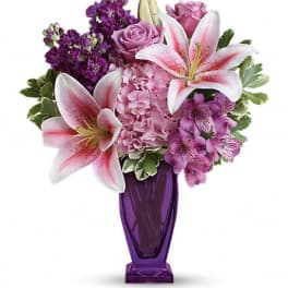 Pink and purple bouquet in a tall purple vase