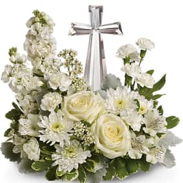 White floral arrangement with a silver cross centerpiece