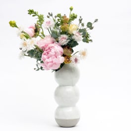 Pink and white floral arrangement in a white vase