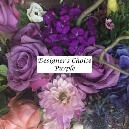 Purple floral arrangement with roses and mixed blooms
