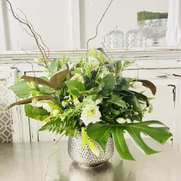 White and green floral arrangement in a hammered silver vase
