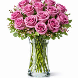 Pink roses arranged in a clear glass vase