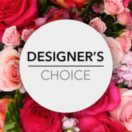 Pink and red roses surrounding a Designer's Choice sign