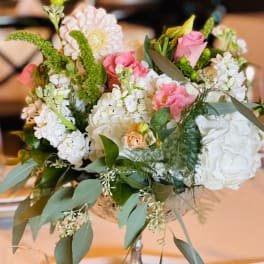 Mixed pink and white floral arrangement in a silver vase