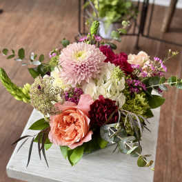 Mixed bouquet with pink and peach roses, a pale pink chrysanthemum, and white hydrangea