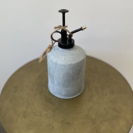 Metal watering can with black spout and twine tag